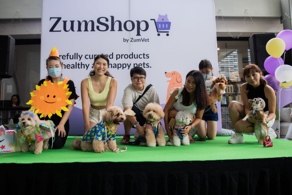 customers with their dogs at Zumshop event stage